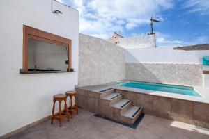 a swimming pool on the side of a house at Casa Celestina in Temisas