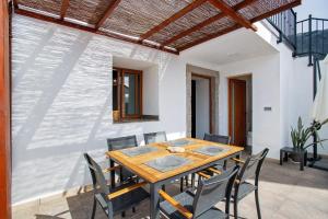 a dining room with a wooden table and chairs at Casa Celestina in Temisas