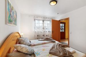 a bedroom with a bed and a mirror at Ferienwohnung Heike Schreiber in Sasbachwalden