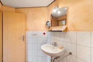 a bathroom with a sink and a mirror at Ferienwohnung Heike Schreiber in Sasbachwalden +19 photos