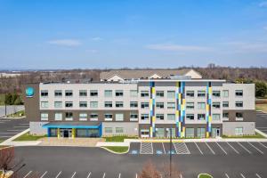 a large white building with a parking lot at Tru By Hilton Hagerstown in Hagerstown