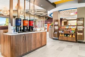 a restaurant with a counter with bottles of wine at Tru By Hilton Hagerstown in Hagerstown