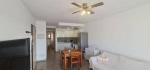 a living room with a ceiling fan and a table at Apartamento La Palma Corralejo in Corralejo