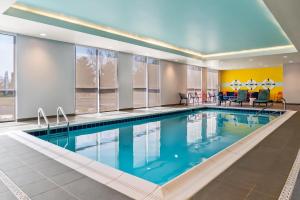 a large pool in a hotel room with blue water at Tru By Hilton Hagerstown in Hagerstown