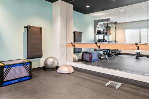 a room with a gym with a table and weights at Tru By Hilton Hagerstown in Hagerstown