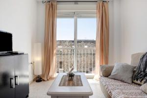 a living room with a couch and a large window at Surfer Tarifa in Tarifa