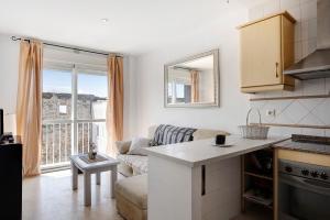 a kitchen and a living room with a couch at Surfer Tarifa in Tarifa
