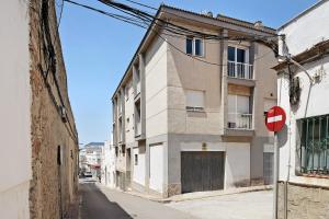 a building on a street with a red stop sign at Surfer Tarifa in Tarifa