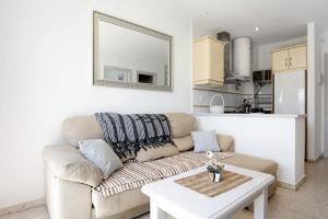 a living room with a couch and a table at Surfer Tarifa in Tarifa +13 photos