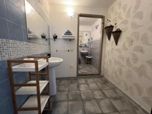 a bathroom with a sink and a mirror at Sa Funtana in Gonnesa