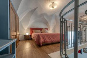 a bedroom with a bed with a red bedspread at La Cartapesta in Lecce
