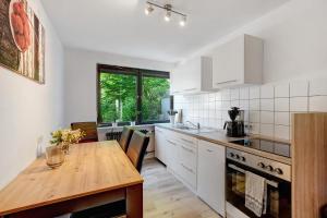a kitchen with a wooden table and a wooden dining table at Ferienwohnung Am Lehen Schiltach in Schiltach