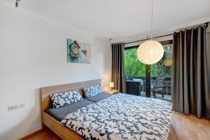 a bedroom with a bed and a large window at Ferienwohnung Am Lehen Schiltach in Schiltach