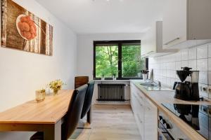 a kitchen with a wooden table and a sink at Ferienwohnung Am Lehen Schiltach in Schiltach +27 photos