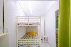 a bunk bed in a small room with a ceiling at Logis Helena in Elne +5 photos