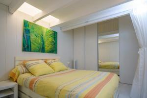 a bedroom with a bed and a painting on the wall at Logis Helena in Elne