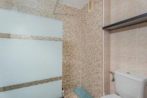 a bathroom with a toilet and a glass shower at Estudio Rebe in Tazacorte