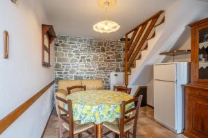a dining room with a table and a refrigerator at Casa Mary in Prataccio