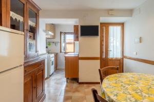 a small kitchen with a table and a dining room at Casa Mary in Prataccio +8 photos
