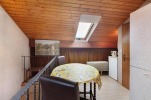 a dining room with a table and a kitchen at Haus Koch in Bad Säckingen