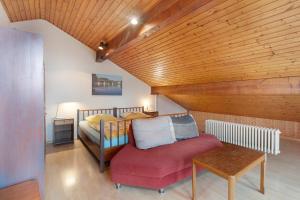 a bedroom with a bed and a chair and a table at Haus Koch in Bad Säckingen