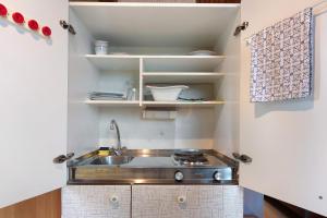 a small kitchen with a sink and shelves at Haus Koch in Bad Säckingen
