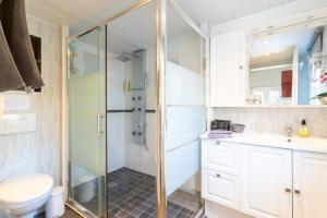 a bathroom with a shower and a toilet and a sink at Logis Du Conflent in Rodès +12 photos