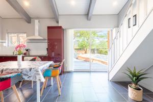 a dining room with a table and chairs and a sliding glass door at Logis Du Conflent in Rodès