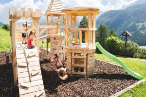 a group of children playing in a wooden playground at Egorta - Egarterhof Sexten in Sesto