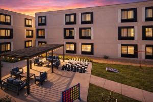 a building with a table and chairs in front of it at Hampton Inn & Suites by Hilton San Diego SeaWorld Near Old Town in San Diego