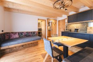 a living room with a table and a couch at Egorta - Egarterhof Sexten in Sesto