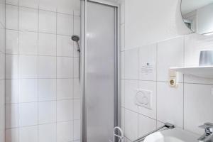 a shower with a glass door in a bathroom at Haus Edith in Gersfeld +17 photos
