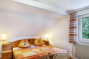 a bedroom with a bed and a window at Haus Edith in Gersfeld