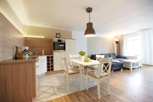 a kitchen and living room with a table and chairs at Haus Strandeck Nordstrand 18 in Göhren