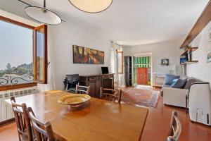 a dining room with a table and a living room at Luca Via Gavazzo 18 in Bonassola