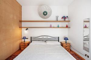 a bedroom with a large bed and two night stands at Luca Via Gavazzo 18 in Bonassola