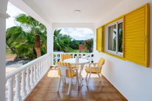 a dining room with a table and chairs on a balcony at Villa Can Andreuet de Baix in Illes Balears