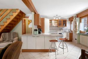 a kitchen with a counter and stools in a room at La Maisonnette in Valtournenche