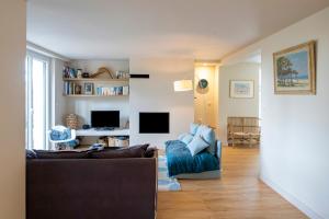 a living room with a couch and a tv at Villa proche du lac d'Hossegor in Soorts-Hossegor