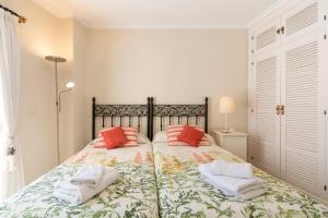 a bedroom with a bed with two towels on it at Deluxe Apartment with Jacuzzi in Marbella