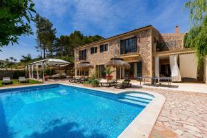 a swimming pool in front of a house at Finca Son Pol in Andratx