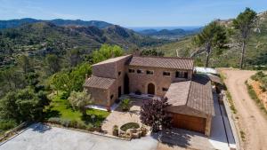an aerial view of a house with mountains in the background at Finca Son Pol in Andratx