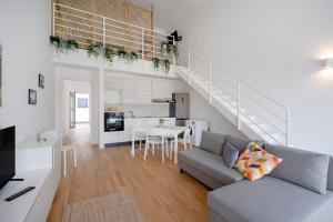 a living room with a couch and a dining room at Dimora Adriatica in Bari