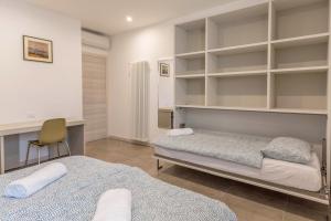 a bedroom with two beds and a desk and a chair at Casa Balansina Lake View in Brenzone sul Garda
