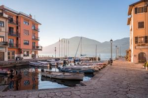 a group of boats are docked in a canal next to buildings at Casa Balansina Lake View in Brenzone sul Garda