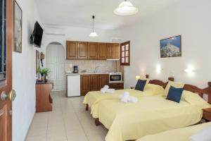 a bedroom with two beds and a kitchen at Studios Asterias 4 in Astypalaia