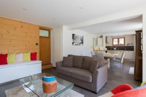 a living room with a couch and a table at La Tour 74 in Thônes +11 photos