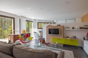 a living room with a couch and a table at La Tour 74 in Thônes