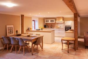 a kitchen with a wooden table and chairs at Fewo Hohe Liebe in Rathmannsdorf