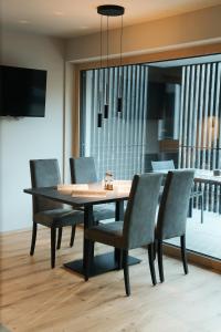 a dining room with a table and chairs at Aktiv Lodge Meran - Terrace Large in San Martino